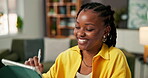 Black woman, smile and writing on stylus at house for research, editing article and copywriting. Person, freelancer and tablet for editor feedback, reading newsletter and draft update for publication