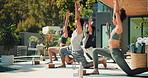People, stretching and workout with yoga class at resort, fitness and trainer with warrior lunge on patio. Men, women and instructor with balance outdoor, exercise and self care at wellness retreat