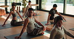 Man, people and stretching for yoga in class, holistic fitness and spiritual balance for self care. Group, community and flexible with spinal twist pose, mindfulness and technique of wellness session