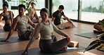 Yoga, class and people in studio with stretching, mindfulness or relax in body wellness. Seated spinal, peace and group in gym with mobility, digestion or posture improvement in shared practice.
