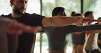Man, people and stretching for yoga in class, holistic fitness and spiritual balance for awareness. Community, warrior pose and group lesson for flexibility, mindfulness and technique for wellness