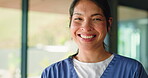 Face, woman and doctor with smile in hospital for career pride, about us and medical service. Portrait, female surgeon and happy with ambition, patient care and positive attitude of healthcare values