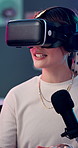 Talking, typing and vr headset with woman in studio for content creation or product review. Computer, microphone and podcast with influencer person in virtual reality for live streaming subscription
