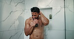Man, shower and singing in home bathroom for cleaning, wellness and washing hair. Male person, house and running water in morning for karaoke, grooming splash and fresh body with cosmetics bottle