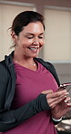 Fitness, typing or woman in gym with phone, funny message or exercise video on social media. Happy, digital or female person in studio with tech, virtual tutorial or meme reaction on workout break.