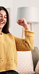 Online, success and smile with woman on sofa for freelancer bonus, job opportunity or winner. Promotion, achievement and celebration with person in living room of house for project award and news
