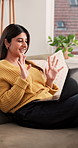 Happy, woman and wave with laptop for video call with discussion, story ideas or interview source. Person, freelancer greeting and talk with pc for webinar, editor feedback and contact client in home