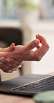 Business person, wrist pain and laptop with stress, carpal tunnel or burnout from typing in office. Employee, hand sprain and inflammation with sore ache, strain or overworked with deadline pressure