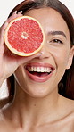 Grapefruit, skincare and face of woman in studio for vitamin c, treatment and cosmetics. Portrait, fruit and model with diy facial, organic or skin detox with citrus cleaning on white background