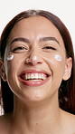 Beauty, woman and laughing with face cream in studio for funny skincare routine, hydration or glow. Cosmetics humor, girl and happy with moisturizer on white background for acne treatment or wellness