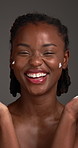 Cream, skincare and black woman with beauty, face and dermatology on grey studio background. African person, smile and lotion with healthy skin, cosmetics and aesthetic with grooming, glow and creme
