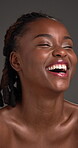 Skincare, black woman or smile with cosmetics in studio. natural beauty or spa treatment for shine. Facial glow, person laugh or dermatology for self care, healthy skin or wellness on gray background