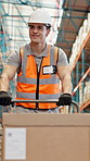 Man, trolley and walking with box at warehouse to transport stock, export cargo and supply chain. Person, cart and delivery of shipping, storage management and inventory for industrial distribution