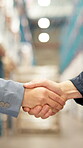 Distribution, handshake and logistics with people in warehouse together for agreement or deal. Partnership, thank you and welcome with supply chain team shaking hands in factory for shipping success
