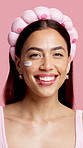 Woman, skincare cream and face in studio with headband, happy and pride on pink background. Person, beauty and lotion with cosmetics, moisturizer and portrait with product for dermatology in Mexico