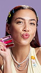 Makeup, lip gloss and face of woman in studio for beauty, lipstick choice and cosmetics shine. Hydration treatment, aesthetic and glow with portrait of person on purple background for self care