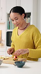 Smile, woman and cutting fruit at house with healthy snack, meal prep and breakfast wellness. Female person, organic and chopping ingredients for vegan salad, nutrition brunch and digestion benefits