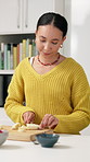 Morning, kitchen and woman cutting banana for healthy meal for detox, diet and nutrition. Home, breakfast and person with fruit, organic food and ingredients for wellness, vitamins and weight loss