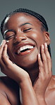 Beauty, facial and laughing with black woman in studio for cosmetics or dermatology satisfaction. Aesthetic, funny and skincare with excited African model on gray background for benefits or results