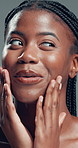 Skincare, face and black woman with beauty, glow and laugh for self care on gray background. Natural cosmetics, funny and model touch skin for wellness, hydration results and dermatology in studio