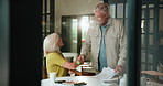 Old couple, handshake and signature with documents in home for finance savings, budget and policy review. Senior woman, man and paperwork for bills, assets and shaking hands for retirement planning