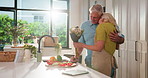 Senior couple, flowers and hug in kitchen with care, present or anniversary with love in home. Elderly man, woman and embrace with floral bouquet, happy or gift with cooking in retirement at house
