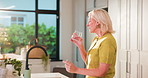 Healthy, water and woman with pill, kitchen and treatment for wellness, vitamins and tablet in home. Happy, mature person and drinking liquid with supplements, healthcare and medicine in apartment
