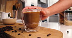Beans, coffee and hands of person in kitchen of home for morning beverage, brewing or cappuccino liquid. Espresso shot, drink and cup of latte with man in apartment for cafe mocha, roast and caffeine