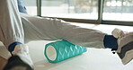 Fitness, foam roller or man in home with stretching, recovery or pain relief in legs. Physio, mobility or athlete on floor with workout equipment, injury prevention or release of muscle tightness.