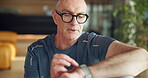 Athlete, senior man and check watch for fitness app, track performance and workout results. Elderly person, wristwatch and monitor for heart rate, exercise progress and time for health stats at house