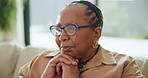 Mature woman, thinking and nostalgia on sofa with ideas, memory or relax in living room in Kenya. Senior African person, vision and remember on lounge couch with choice or decision in apartment