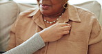 Woman, nurse and hands checking breathe in elderly care on living room sofa for healthcare at home. Female person, medical caregiver and monitoring mature patient for cardiovascular exam at house