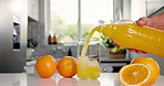 Hands, kitchen and pour orange juice for nutrition, healthy diet and bottle with vitamin c. Citrus, person and glass jar with fruit, organic beverage and natural drink with ice for breakfast in home