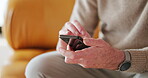 Typing, hands or elderly man on sofa with phone, news or chat update on social media network. Digital, scroll or senior person in home with tech, online communication or internet search on mobile app