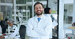 Face, scientist and man with arms crossed, lab or confident for drug discovery or career development. Happy, person and pharmaceutical innovation with biotechnology, medical professional and team