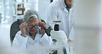 Scientist, woman and microscope with glasses for chemistry, testing and medical research. Biotech, laboratory and analysis with DNA inspection for pathology experiment, synthesis and microbiology