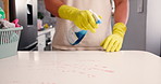 Hands, man and clean with spray on kitchen counter, hygiene and home maintenance to prevent germ spread. Disinfectant tools, surface cleaner and housekeeper with sanitize tabletop, tidy and wipe dirt