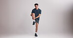 Exercise, face and man with stretching in studio to start workout, muscle flexibility and wellness. Mockup space, leg fitness and athlete with static warm up on white background for physical activity
