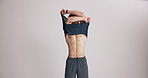 Man, bodybuilder and remove shirt in studio, thinking or inspection with mock up space on white background. Person, strong and fitness with transformation, muscle and check results for progress