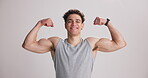 Face, athlete and happy with flex in studio for fitness progress, muscle growth and workout results. Bodybuilder, man and pride with strong biceps on white background for body transformation or goals