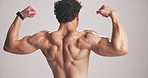 Studio, biceps and man flex muscle for growth, development and strength with power. Strong back, shirtless person and bodybuilder with fitness progress, exercise or physique on white background space