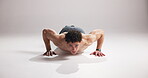 Face, man or push up in studio with fitness, strength training or exercise challenge for calisthenics. Active, person or athlete on white background for space, endurance workout or muscle development