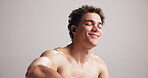 Topless man, earphones and fitness in studio, listening to music or motivation with training playlist. Dancing, audio tech and person ready for exercise with sports radio space on white background