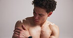 Man, shirtless and shoulder pain for fitness injury in studio, fibromyalgia or overworked muscle with pressure. Tendon ache, inflammation and male athlete with massage for relief on white background