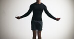 Skipping, man and hands with rope, studio and cardio for fitness, mockup space and white background. Healthy, exercise and person with energy for routine, wellness and active for practice for sport