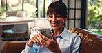 Reading, smile or mature woman on sofa with phone, entertainment update or funny post on online app. Digital, scroll and female person in house with tech, meme reaction or good news on email.