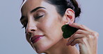 Gua sha, natural beauty and face of woman in studio for facial, lymphatic drainage or massage. Skincare, dermatology and portrait of person with jade stone for anti aging benefits on white background
