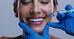 Hands, lip filler injection and woman in studio for plastic surgery, beauty or smile on background. Mature person, surgeon and happy with syringe for cosmetics, patient or collagen for transformation