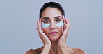 Face, skincare and woman with eye mask for beauty, collagen treatment or dermatology. Portrait, cosmetic or gel pad for dark circles, detox product or anti aging for mature model on studio background