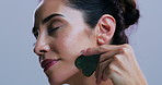 Gua sha, skincare and woman in studio for natural beauty, lymphatic drainage and massage. Wellness, dermatology and person with jade stone for anti aging, facelift and benefits on white background